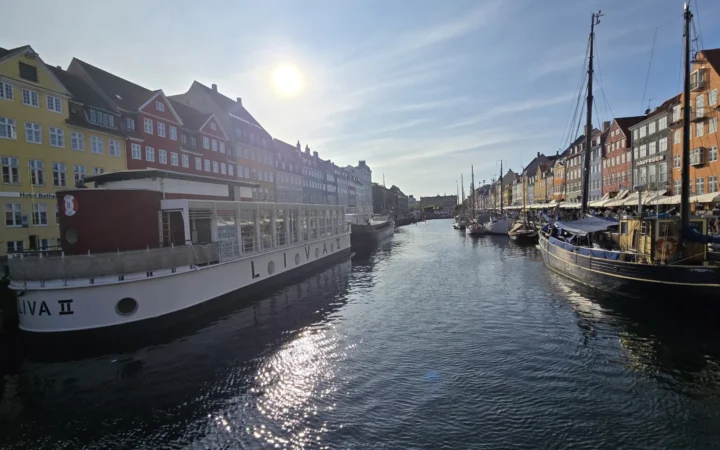 Colorful buildings and boats along a Copenhagen waterfront canal