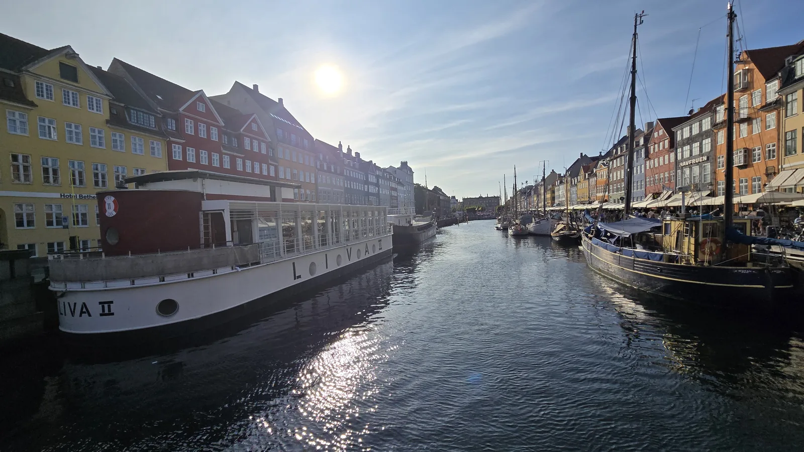 Colorful buildings and boats along a Copenhagen waterfront canal