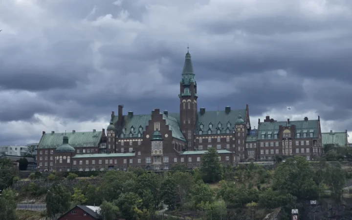 Waterfront and a large historic building seen from the water in Stockholm