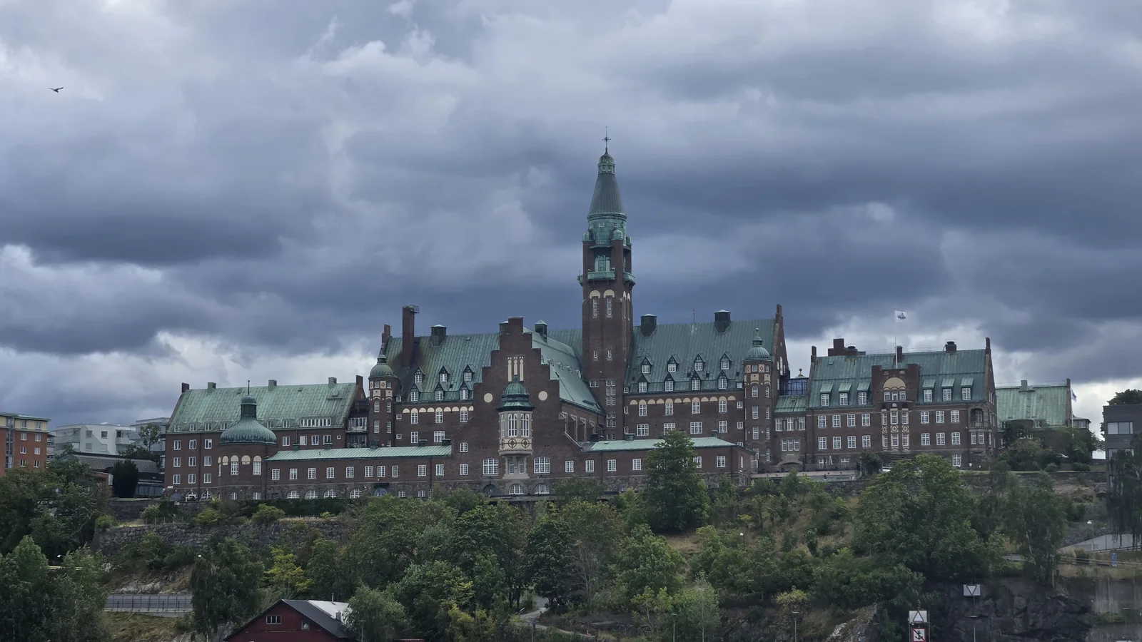 Waterfront and a large historic building seen from the water in Stockholm