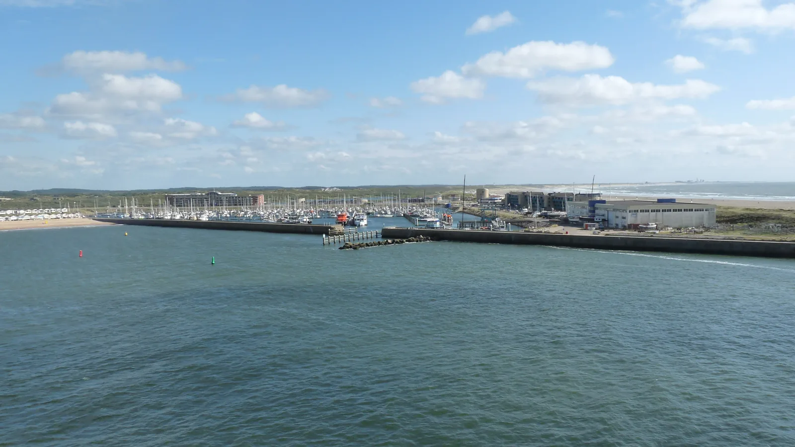 Marina Seaport IJmuiden and the North Sea shoreline across the harbor entrance