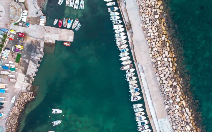 Aerial view of Civitavecchia marina, breakwater and turquoise harbor water