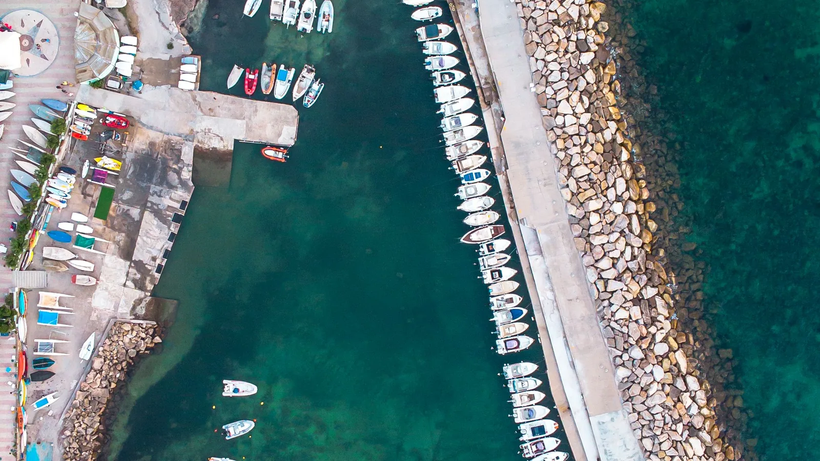 Aerial view of Civitavecchia marina, breakwater and turquoise harbor water