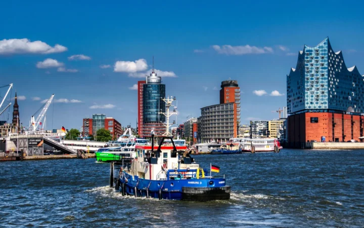 A workboat on the Elbe with Hamburg’s waterfront skyline and Elbphilharmonie behind