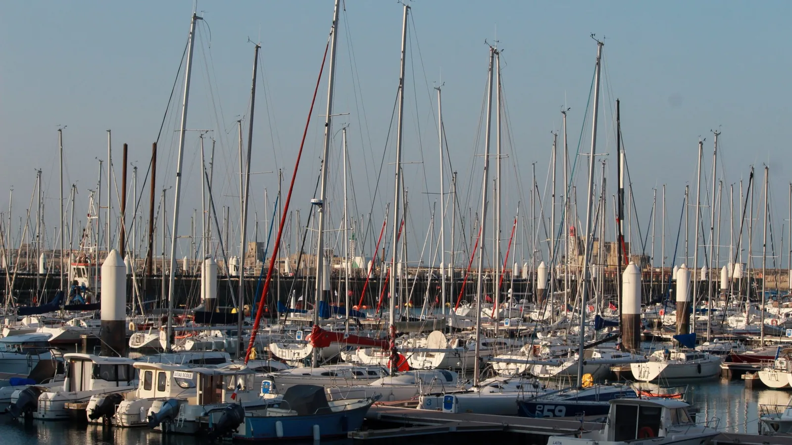 Sailboats in Le Havre Marina with the port skyline beyond