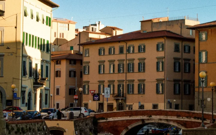 Boats along a canal and historic waterfront buildings in Livorno