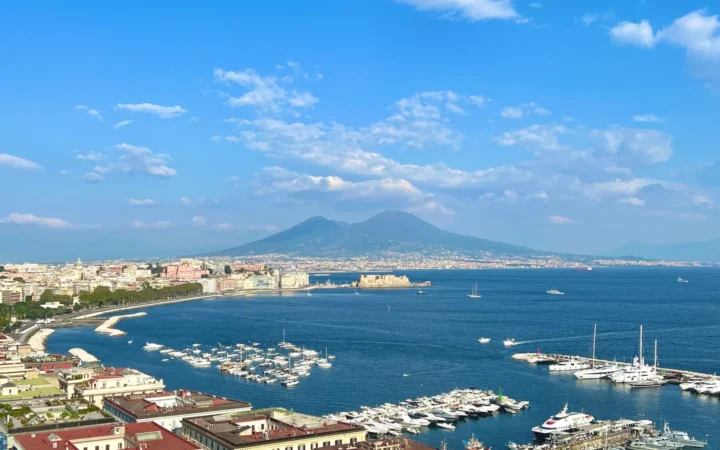 Naples waterfront and marinas across the bay with Mount Vesuvius beyond