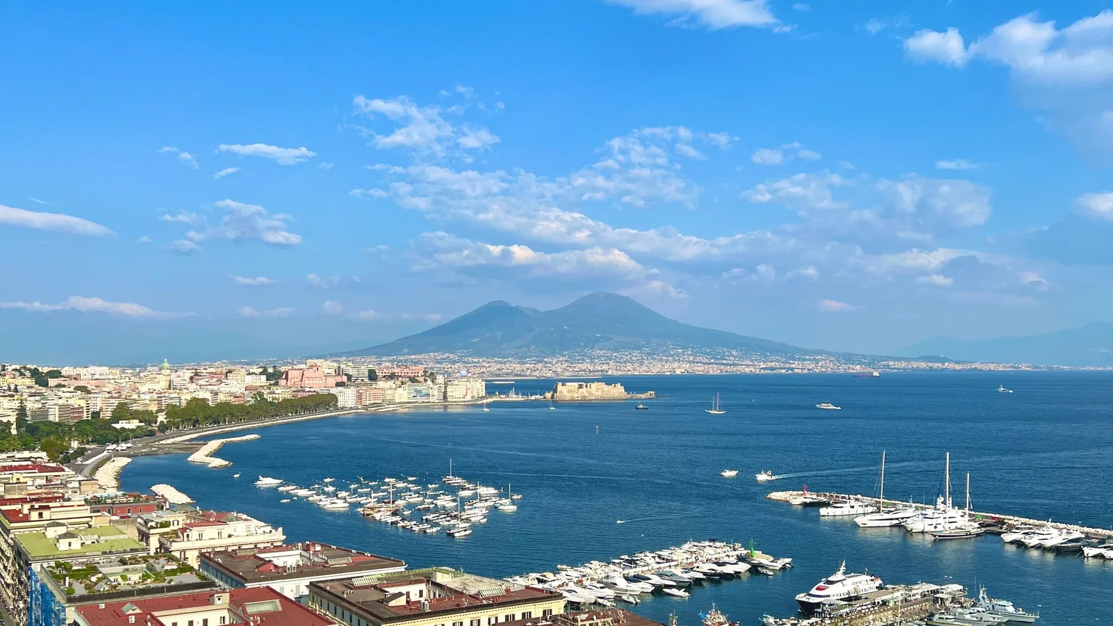 Naples waterfront and marinas across the bay with Mount Vesuvius beyond