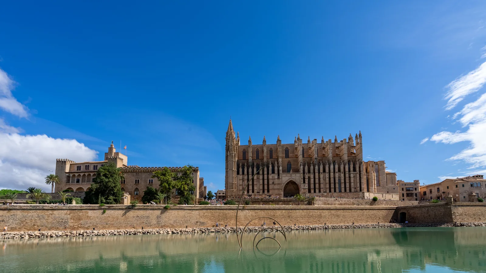 La Seu cathedral and historic waterfront walls beside the water in Palma de Mallorca