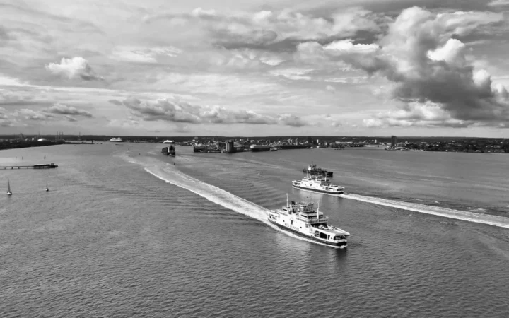Ferries crossing Southampton Water beneath a dramatic cloudy sky