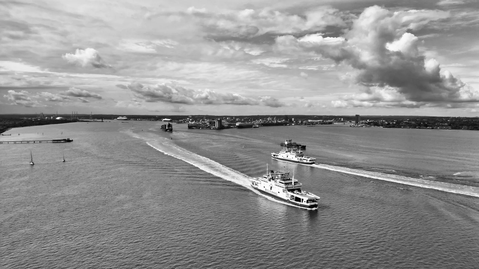 Ferries crossing Southampton Water beneath a dramatic cloudy sky
