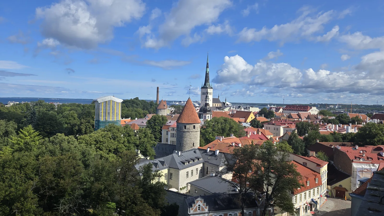 Tallinn old-town rooftops and church towers beneath a blue sky