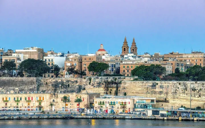 Valletta’s limestone waterfront and fortified city skyline across the harbor