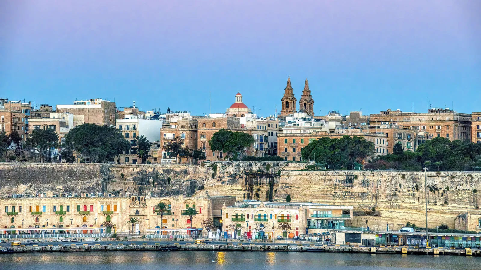 Valletta’s limestone waterfront and fortified city skyline across the harbor