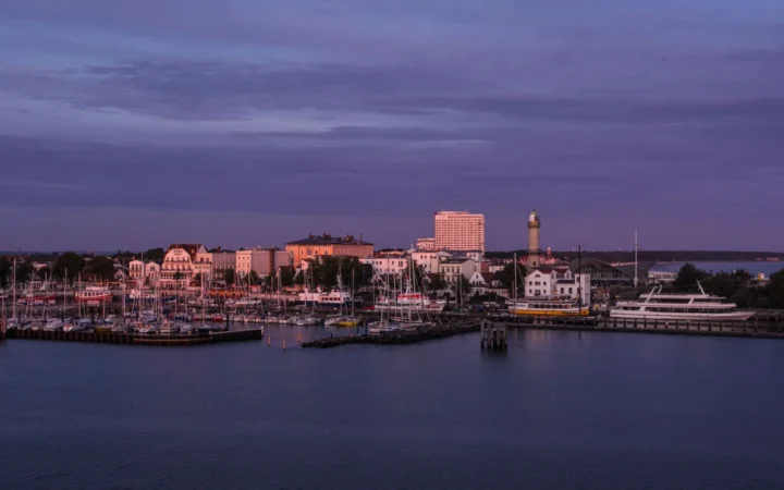 Warnemünde waterfront, marina and lighthouse across the harbor at dusk